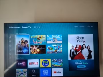 Hisense 58in Roku TV R6 Series 4K UHD LED Smart TV, including the table