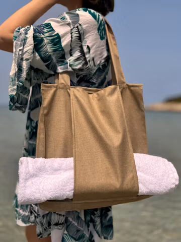 Womens beach bag with separate towel pocket and dual handles, Versatile summer tote bag design, Beige pool bag with pocket for phone inside.