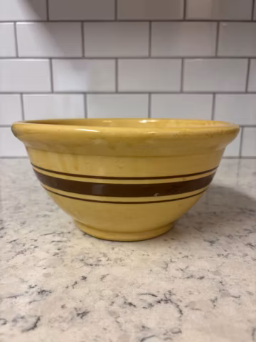 Vintage Weller yellowware mixing bowl with brown stripes.