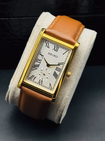 Rare Vintage Seiko Slim Gold Rectangular Seiko wrist watch Tan leather strap, Roman numerals