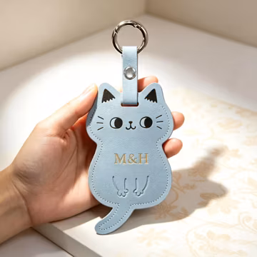 Cartoon Cat Leather Bag Charm with Embossed Face Paw Detail Riveted Loop Strap Custom Monogram Gift Pet Lover Souvenir Accessory