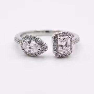 Silver Twin Toi Diamond Ring, Adjustable Ring, Pear Cut Stone Face To Face With An Emerald Cut Stone, Encircled By Micro Pave Diamond Halos